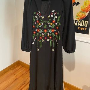 Black boho dress with embroidered flowers.